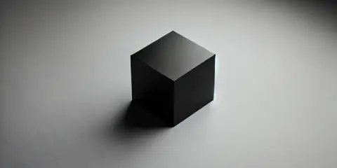 Cubo negro aislado sobre fondo gris, listo para pruebas de caja negra.