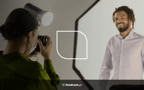 Fotógrafa toma fotos para CV de un hombre sonriente.